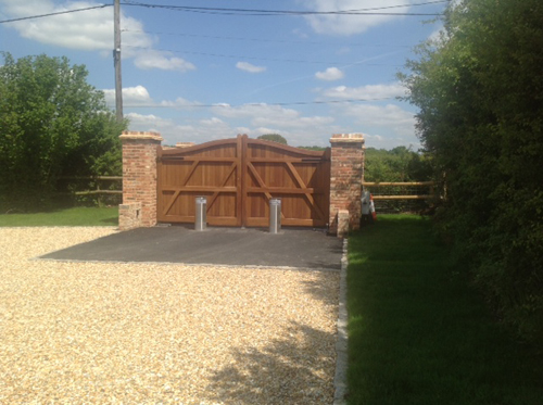 Handmade wooden automatic security gates on a driveway